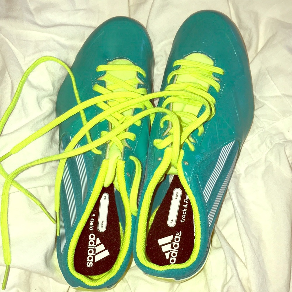Neon green and teal track and field cleats